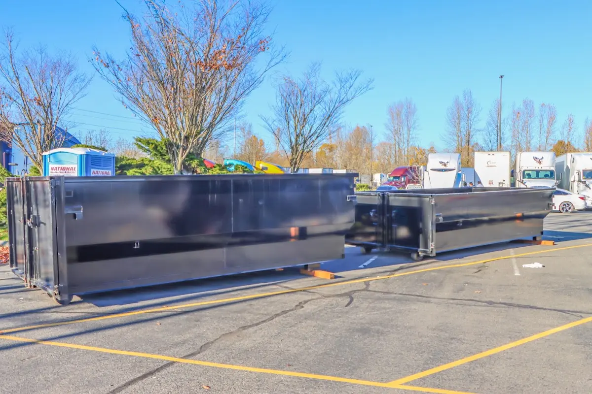 Professional dumpster rental service with roll-off container on residential driveway in Sun Valley